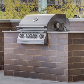 a brick wall with a grill on top of it